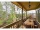 Outdoor patio features a dining table, seating for six, and privacy overlooking a wooded area at 2659 Lakefield Sw Pass, Marietta, GA 30064
