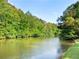 Scenic view of a peaceful pond surrounded by lush greenery at 2659 Lakefield Sw Pass, Marietta, GA 30064