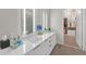 Sleek Primary bath with double sinks, lighted mirrors, and a view of a walk-in closet at 40 12Th Ne St # 903, Atlanta, GA 30309