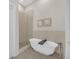 Modern bathroom features a sleek soaking tub and a glass-enclosed shower at 40 12Th Ne St # 903, Atlanta, GA 30309