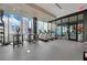 Bright gym with cardio machines, weights, and large windows with city views at 40 12Th Ne St # 903, Atlanta, GA 30309