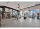 Modern gym with fitness equipment, weights, and mirrors overlooking city views at 40 12Th Ne St # 903, Atlanta, GA 30309