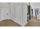 Contemporary hallway showing sleek doors and hardwood floors leading to a modern kitchen at 40 12Th Ne St # 903, Atlanta, GA 30309