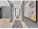 Hallway with gray walls, light wood floor, carpet runner and abstract wall art at 40 12Th Ne St # 903, Atlanta, GA 30309