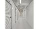 An interior hallway with multiple closed storage units, white walls, and overhead lights at 40 12Th Ne St # 903, Atlanta, GA 30309