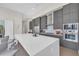 Sleek, modern kitchen with stainless steel appliances and a large center island with seating at 40 12Th Ne St # 903, Atlanta, GA 30309