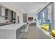 Bright living room with floor to ceiling windows and open layout to the kitchen area at 40 12Th Ne St # 903, Atlanta, GA 30309