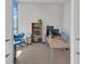 Bright home office featuring a large desk, shelving, and comfortable blue chair near a window at 40 12Th Ne St # 903, Atlanta, GA 30309