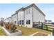 Charming backyard featuring a black fence, lush green grass, and landscaped planter beds with potential for gardening at 501 Blackberry Ln, Canton, GA 30115