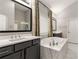 Bright bathroom with marble countertops, soaking tub, and modern fixtures at 501 Blackberry Ln, Canton, GA 30115