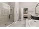 Modern bathroom with large glass shower, soaking tub, and neutral color palette at 501 Blackberry Ln, Canton, GA 30115