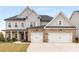 Beautiful two-story home features a brick and gray color scheme, two-car garage, and manicured lawn at 501 Blackberry Ln, Canton, GA 30115