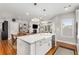 Modern kitchen features a center island with a sink, stainless steel appliances, and open floor plan at 501 Blackberry Ln, Canton, GA 30115