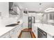 This kitchen features modern appliances, white cabinetry, and a spacious island with a stainless steel farmhouse sink at 501 Blackberry Ln, Canton, GA 30115