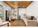 Cozy living room showcasing a wood plank ceiling, natural light, and comfortable seating arrangement at 501 Blackberry Ln, Canton, GA 30115