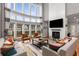 Open living room with soaring windows and fireplace, offering abundant natural light and a cozy atmosphere at 501 Blackberry Ln, Canton, GA 30115