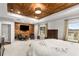 Large main bedroom with a wood accent wall, carpet floors, and windows with backyard views at 501 Blackberry Ln, Canton, GA 30115
