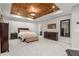 Spacious main bedroom with a unique wood tray ceiling, soft carpet, and plenty of closet space at 501 Blackberry Ln, Canton, GA 30115