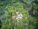 Beautiful aerial view of home nestled amongst trees with pond and circular driveway at 5894 Highway 20 Ne, Cartersville, GA 30121