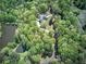 Aerial view of private wooded lot with a meandering drive, pool, and peaceful surroundings at 5894 Highway 20 Ne, Cartersville, GA 30121