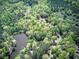 Breathtaking aerial shot of residence featuring a private lake and surrounding tree coverage at 5894 Highway 20 Ne, Cartersville, GA 30121