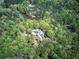Beautiful aerial view of home surrounded by mature trees and a private lake at 5894 Highway 20 Ne, Cartersville, GA 30121
