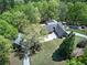 Bird's eye view of estate home with brick exterior, mature trees, and swimming pool at 5894 Highway 20 Ne, Cartersville, GA 30121