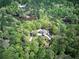 Overhead view of home surrounded by lush trees and overlooking a private lake at 5894 Highway 20 Ne, Cartersville, GA 30121
