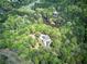 Stunning aerial view of home nestled amongst lush trees with pond and circular driveway at 5894 Highway 20 Ne, Cartersville, GA 30121