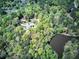 Aerial view of estate with tree coverage near a pond and circular driveway at 5894 Highway 20 Ne, Cartersville, GA 30121