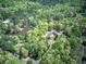 Scenic aerial view of estate surrounded by lush trees and a serene pond, providing privacy at 5894 Highway 20 Ne, Cartersville, GA 30121