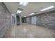 Finished basement with brick walls, tiled floors, and access to a staircase leading to another level at 5894 Highway 20 Ne, Cartersville, GA 30121