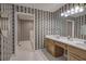 Spacious primary bath with double sink vanity, soaking tub, and decorative wallpaper at 5894 Highway 20 Ne, Cartersville, GA 30121