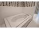 Bright bathroom featuring a tiled tub with jacuzzi jets at 5894 Highway 20 Ne, Cartersville, GA 30121
