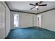 Spacious bedroom features neutral walls, trim, and blue carpet at 5894 Highway 20 Ne, Cartersville, GA 30121