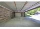 Covered carport area with brick exterior, concrete floor, and access to garage at 5894 Highway 20 Ne, Cartersville, GA 30121