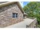 Brick house featuring a spacious deck overlooking a serene backyard with lush landscaping at 5894 Highway 20 Ne, Cartersville, GA 30121