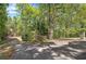 Long driveway leads to a secluded property surrounded by a forest, offering privacy and natural beauty at 5894 Highway 20 Ne, Cartersville, GA 30121