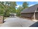 Long driveway leading to the house and detached garage surrounded by mature trees and landscaping at 5894 Highway 20 Ne, Cartersville, GA 30121