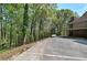 Spacious driveway leading to a brick home, surrounded by lush trees and mature landscaping at 5894 Highway 20 Ne, Cartersville, GA 30121