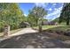 Picturesque home exterior with a long driveway, mature trees, and well-maintained lawn creates a peaceful setting at 5894 Highway 20 Ne, Cartersville, GA 30121