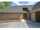 Charming brick home with a wooden front door and manicured landscaping, creating curb appeal at 5894 Highway 20 Ne, Cartersville, GA 30121
