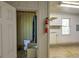 A utilitarian bathroom, with a toilet, is located off the garage at 5894 Highway 20 Ne, Cartersville, GA 30121