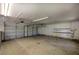 Spacious garage interior featuring storage shelves, overhead lighting, and garage door openers at 5894 Highway 20 Ne, Cartersville, GA 30121