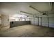 Spacious garage interior with white walls, concrete floor, and block wall with storage, and overhead lighting at 5894 Highway 20 Ne, Cartersville, GA 30121