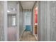Hallway with multiple doorways, tile flooring, and wood-paneled walls leads to various rooms within the house at 5894 Highway 20 Ne, Cartersville, GA 30121