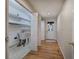Laundry room with ample shelving and a utility sink located near a door and hallway at 5894 Highway 20 Ne, Cartersville, GA 30121