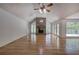 Spacious living room with hardwood floors, a brick fireplace, large windows, and a vaulted ceiling at 5894 Highway 20 Ne, Cartersville, GA 30121