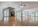 Expansive living room with a cozy brick fireplace, hardwood floors, and abundant natural light at 5894 Highway 20 Ne, Cartersville, GA 30121