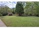 Expansive front yard featuring a large grassy area and mature trees, enhancing the property's curb appeal at 5894 Highway 20 Ne, Cartersville, GA 30121